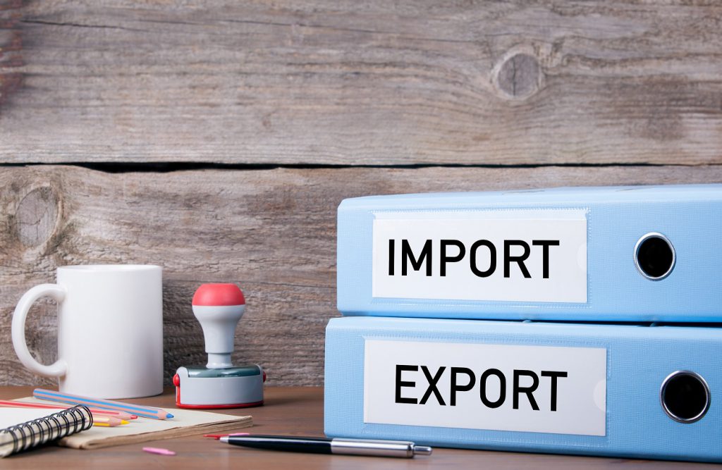 Binders on a import and export company desk, labeled "import" and "export" respectively