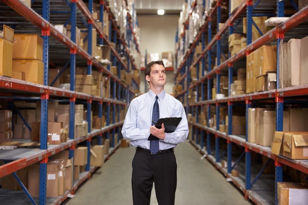 customs broker taking inventory in a warehouse, one of the many warehouse services Cordova Brokerage International