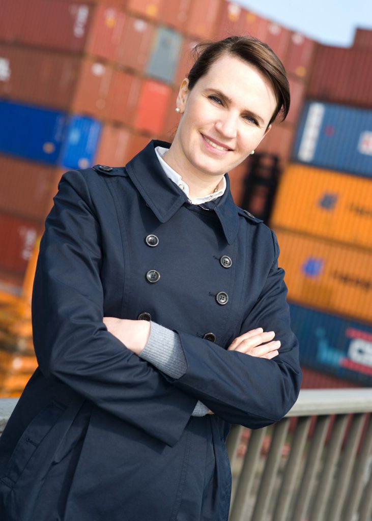 broker standing in front of transportation crates