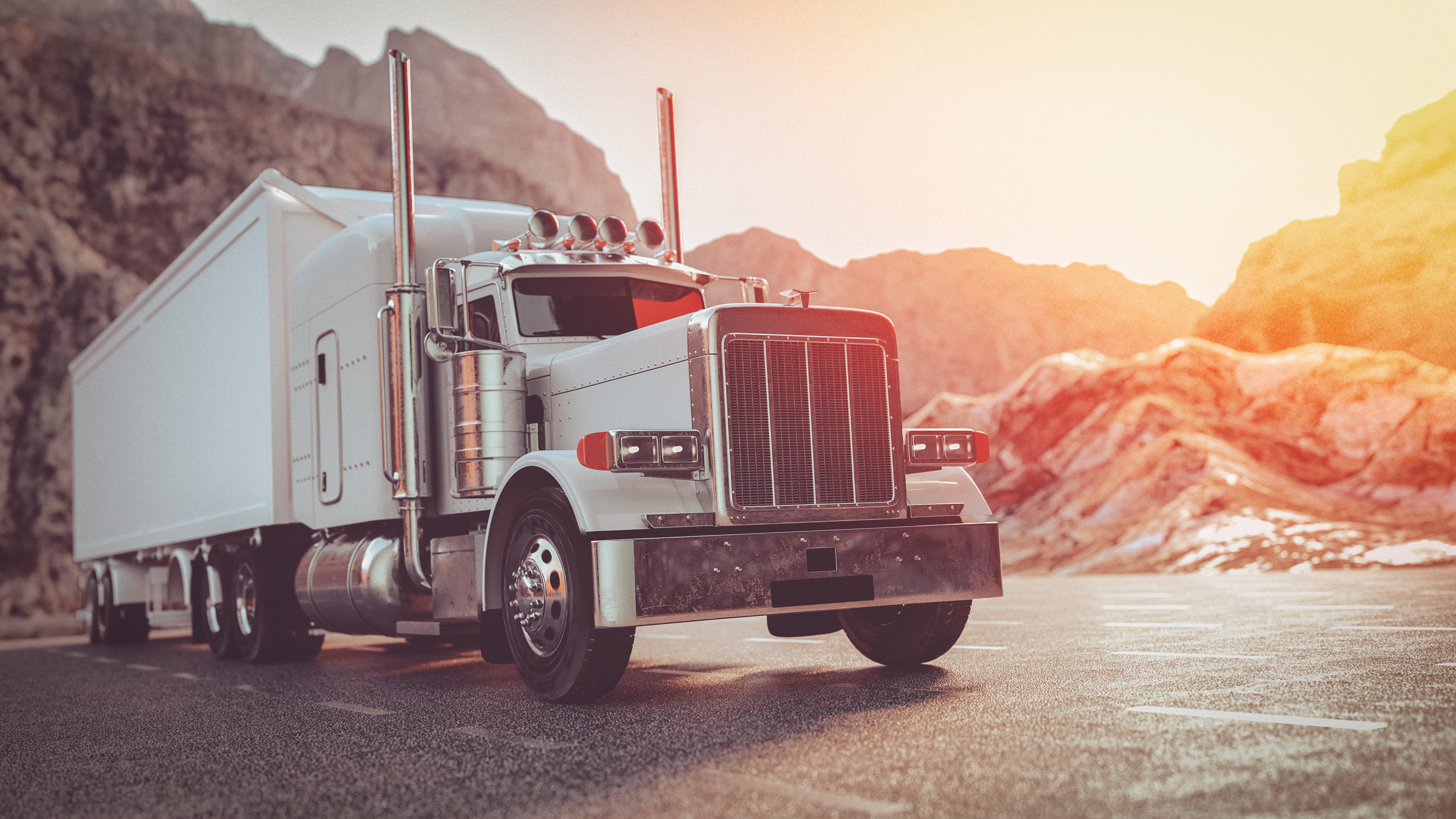 A white truck running on the street in the morning.