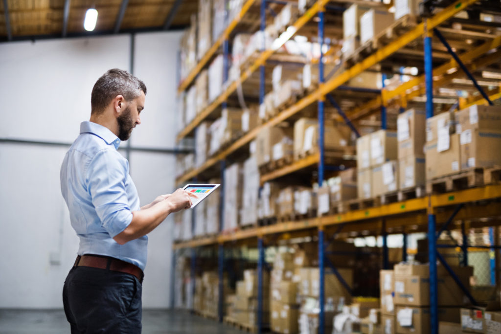 Male warehouse worker with a tablet.